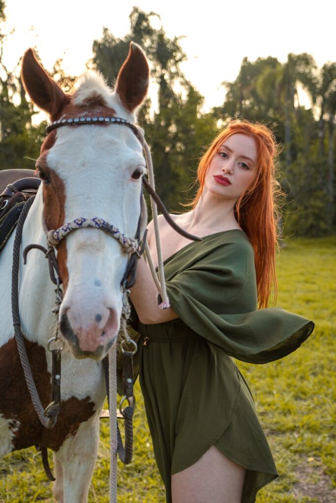 Redhead Woman Posing near Horse in Nature